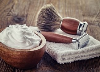 shaving cream and shaving items on a table with a towel