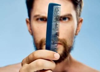 man seeing fallen beard hair on a comb