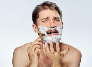 man shaving with razor bumps