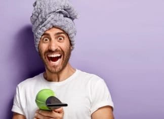 bearded man pointing a blow dryer