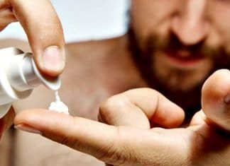man applying beard growth cream